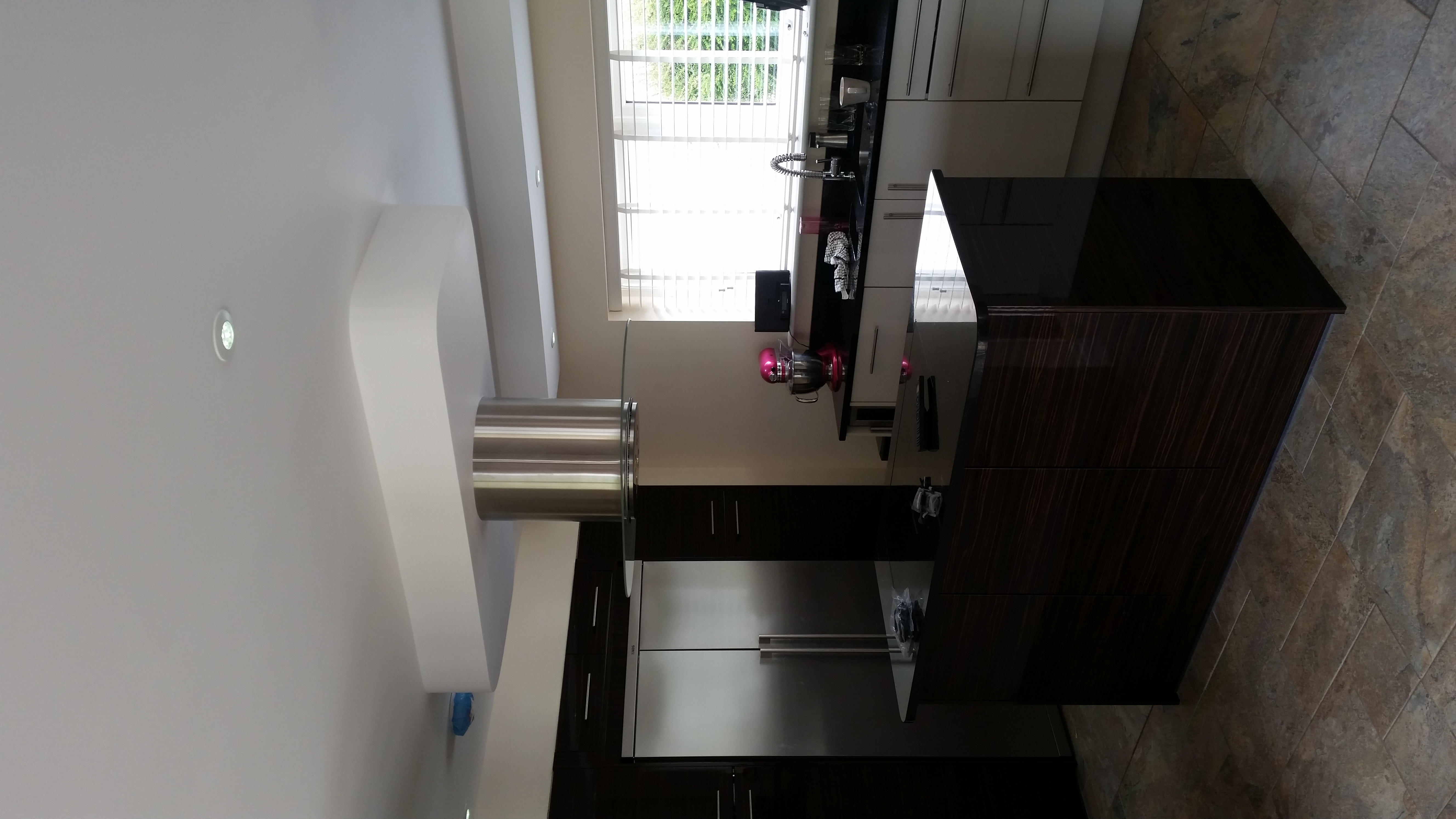 Dark cabinetry, contrasting light cabinets and a large central island